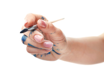 Painted female hand with brush on white background