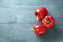 Ripe Red Peppers On Wooden Background
