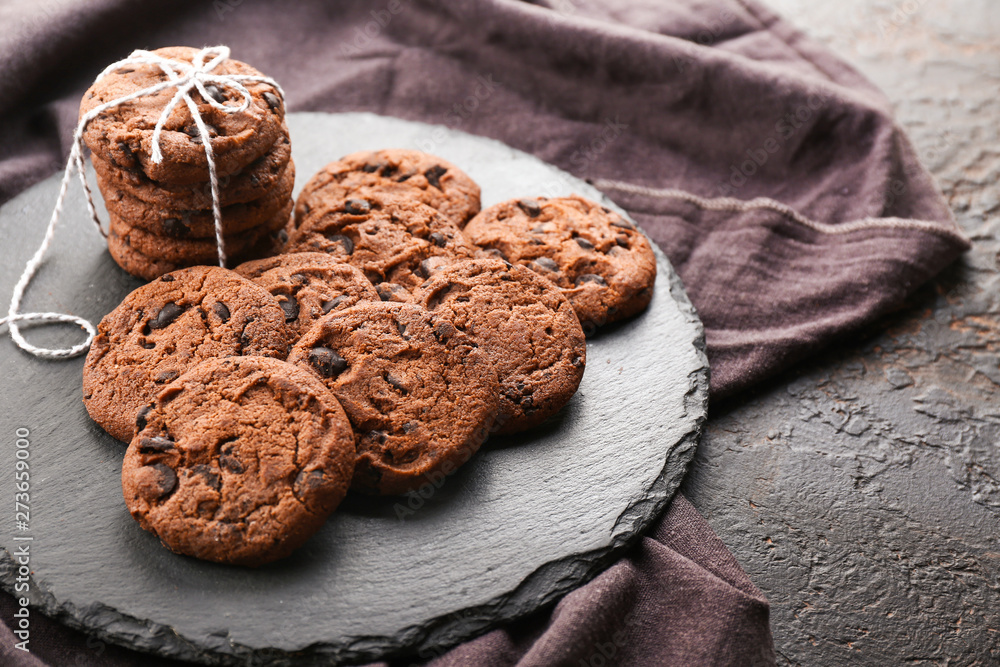 Tasty chocolate cookies on slate plate