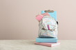© Pixel-Shot - School backpack with stationery on table against light background