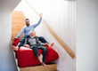 © Halfpoint - An adult hipster son and senior father indoors at home, having fun.