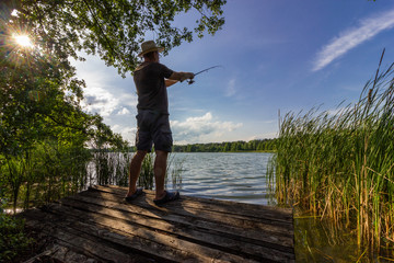 angler catching the fish during summer day