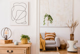 Fototapeta Boho - The stylish boho interior of sitting room in cozy apartment with design coffee table, gray sofa, honey yellow pillows, plaid, wooden shelf, plants and elegant personal accessories. Mock up paintings.