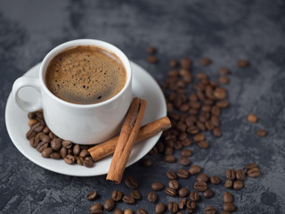 White Cup of espresso coffee with cinnamon on the copyspace concrete table