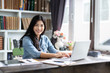 © Have a nice day  - Young Asian Chinese businesswoman do document with a laptop in home office while smiling,technology for startup business concept,entrepreneur working modern living room ,work at home,freelance career