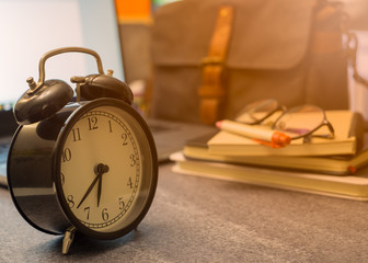 Close-up of Retro alarm black clock vintage style in morning time on the top table. Wake, Ready go to work.