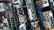 Aerial View Of New York Downtown Building Roofs With Water Towers. Bird's Eye View From Helicopter Of Cityscape Metropolis Infrastructure, Traffic Cars Moving On City Streets And District Avenues
