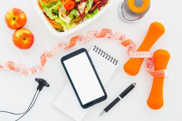 Canvas Print - Fitness healthy and dieting plan mockup on tablet with blank screen mobile phone for mockup, earphone, bottle of water, salad, apples and measuring tape. Fitness nutrition, diet, healthy lifestyle