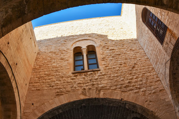 Wall Mural - Beautiful  Corte del Catapano, ancient walls with blue sky  in the Old Town of Bari, Italy. 