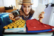 woman with retro film photo camera and map packing for travel