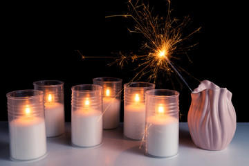 Burning candles on a white background next to the fireworks. Obon festival. Diwali festival