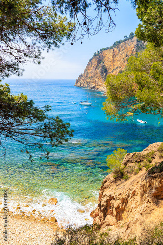 Cuadros en Lienzo Sailboat in beautiful sea bay near Cala Giverola, most beautiful beach on Costa