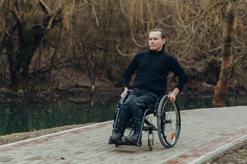 Portrait of a happy man on a wheelchair in a park