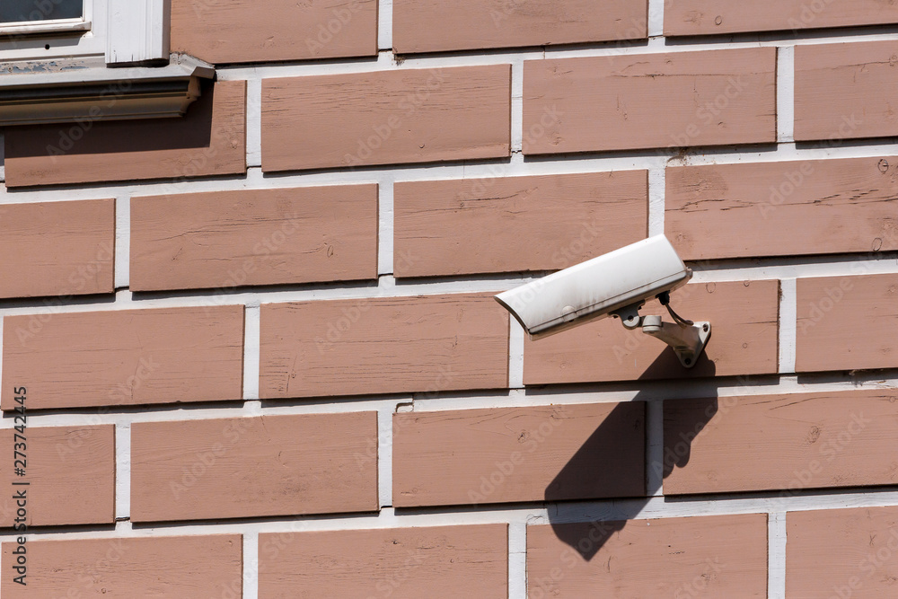 Surveillance camera and monitoring on the wall of the house. modern ...