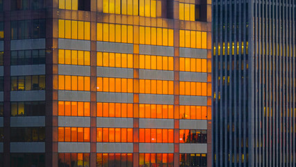 CLOSE UP: Burnt orange evening sky reflects off the windows of skyscrapers.