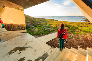 Wall Mural - Andoya island sea coast and tourist with norwegian flag