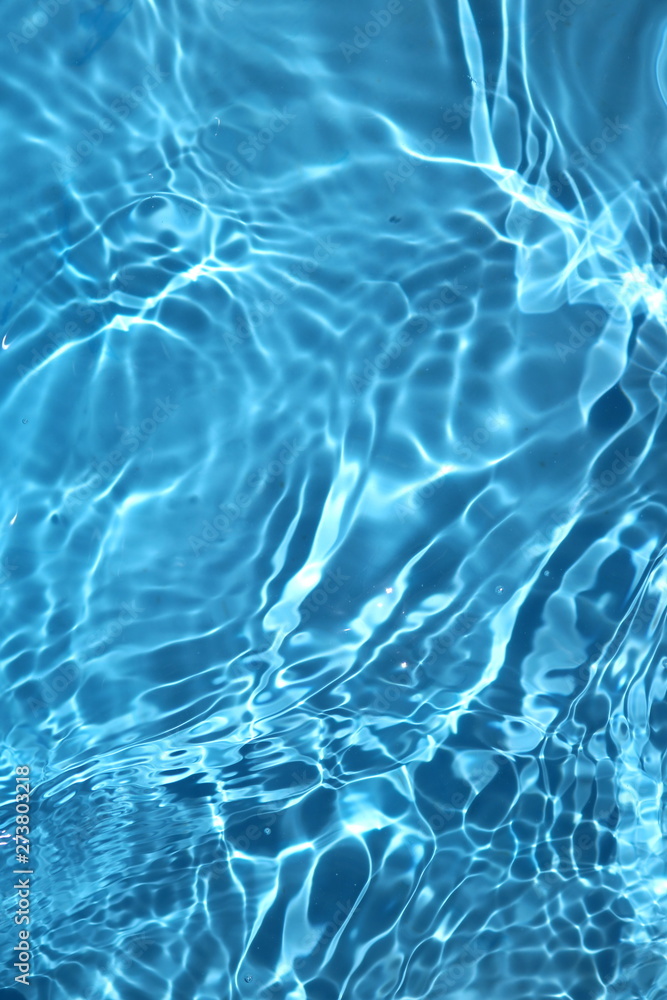 Blue and bright water surface with sun refection in swimming pool for background - obrazy, fototapety, plakaty 