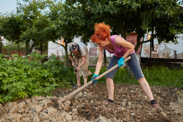 Mother and daughter working in the garden