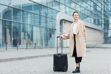 . business woman at international airport moving to terminal gate for airplane travel trip - mobilit