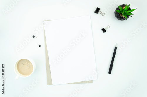 Office Desk Table With Supplies Cup Of Coffee And Blank A4 Paper