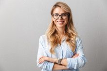 Photo Of Happy Blond Businesswoman Wearing Eyeglasses Smiling And Standing With Hands Crossed