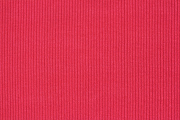 Ribbed textile material, in fine-knit stretch fabric. Knitwear texture. Amaranth color background.