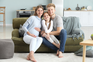 Canvas Print - Beautiful pregnant woman with her family at home