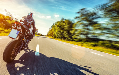 Wall Mural - motorbike on the road riding high speed. having fun riding the empty road on a motorcycle tour / journey