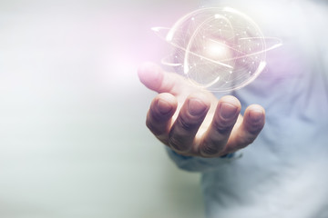 Poster - Human hand holding sphere social connection technologies  with atom on a white background. Mixed media.