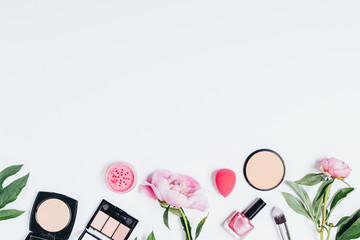 Flat lay composition of feminine makeup products