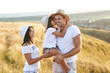 © Studio Romantic - Happy family playing on nature in summer at sunset.
