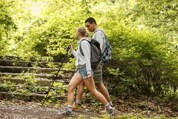 Wall Mural - young couple hiking in nature.they enjoying in walk and fresh air.