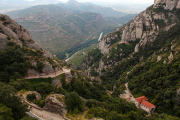 Mountains of Montserrat in Catalonia, Spain. Beautiful top vie on the green hills and stones. Sky and rocks. Panoramic view on the hills and nature in Montserrat 