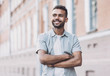 © kite_rin - Portrait of handsome smiling young man with folded arms. Laughing joyful cheerful men with crossed hands in a city