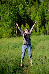 Wall Mural - Young beautiful asian girl having fun and jumping in the forest