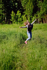 Wall Mural - Young beautiful asian girl having fun and jumping in the forest