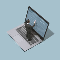 Businessman analyzing a financial chart on a laptop