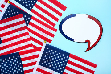 American flags with speech bubble on blue background