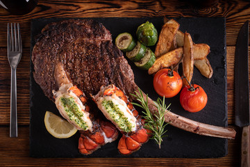 Wall Mural - surf and turf with tomahawk rib eye steak and lobster tail