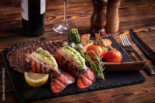 Fotomural surf and turf with tomahawk rib eye steak and lobster tail