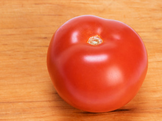 Tomato on a wooden background