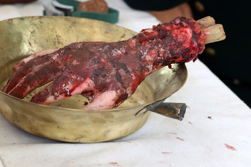 Fake severed human hand in a bowl. Concept of military field hospital, a historical reconstruction of medicine in 19th century