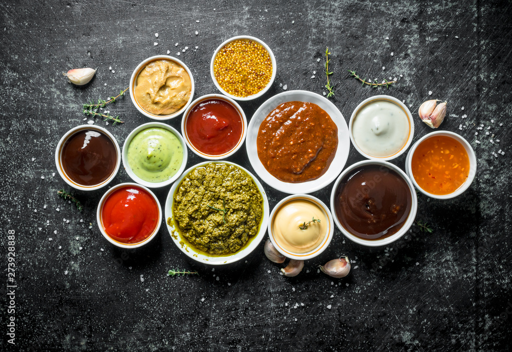 Pesto sauce, guacomole, ketchup, mustard, barbecue sauce in bowls. - obrazy, fototapety, plakaty 