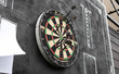 .area for playing darts with a sheet of glasses on a black background. Darts and darts scoreboards