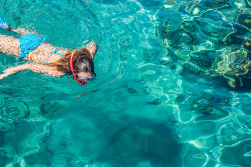 sexy girl swimming and snorkeling in Red sea beautiful aquamarine water exotic natural environment, enjoy in summer cruise vacation time concept picture with empty copy space for text