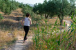 © Cristian Blázquez - Fit middle-aged woman running through a rural field
