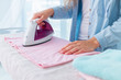 © Goffkein - Ironing of linen and clothes after washing on ironing board