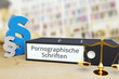 Pornographische Schriften – Recht/Gesetz. Ordner auf Schreibtisch mit Beschriftung neben Paragraf und Waage. Anwalt