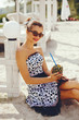 © hetmanstock2 - Beautiful girl with a pineapple. Lady in a retro dress. Woman in a sunglasses