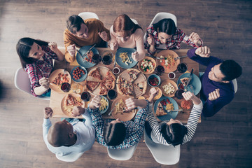 Close up top above high angle view photo festive hooray yeah company social crowd event members arms hands fists raised best competitive vacation sit table shirts sweater pullover loft room indoors